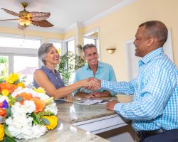 Couple shaking hands with hotel concierge